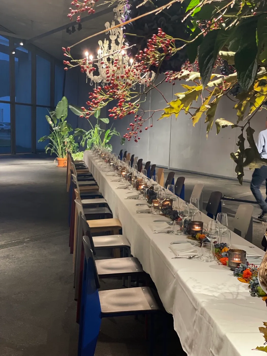 Long industrial-style table — wedding catering with chandeliers